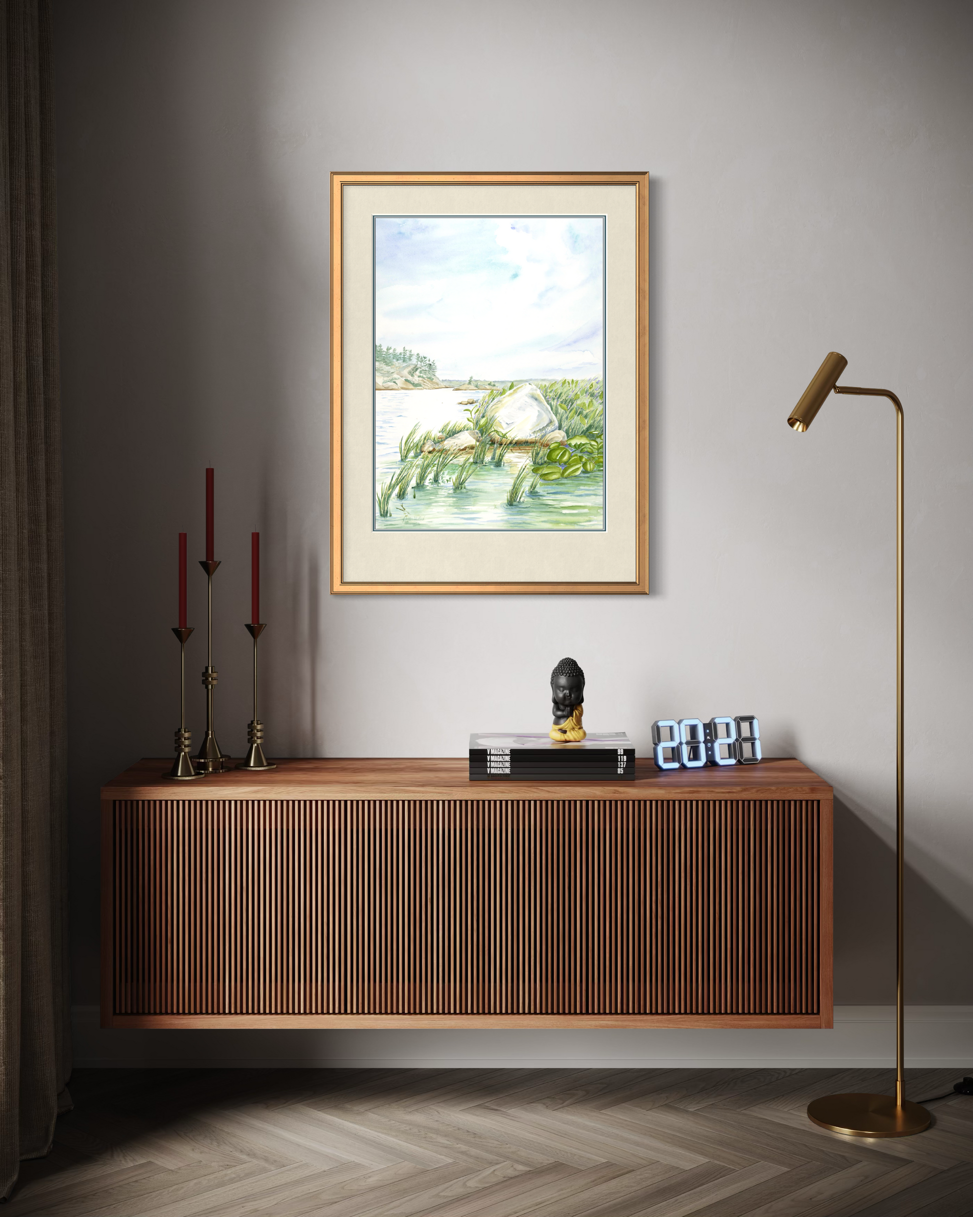 Framed Granite and Wind watercolor print of Georgian Bay shoreline displayed in a modern interior with warm wood furniture.