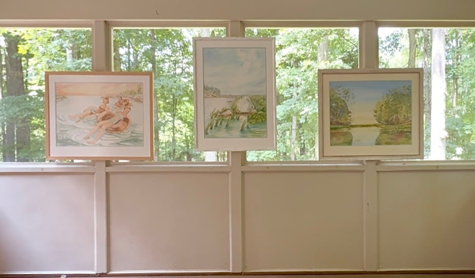 Three framed original watercolor paintings from Pamela Hallock's Georgian Bay Collection displayed together in a gallery setting with Turtle Bay on the right.