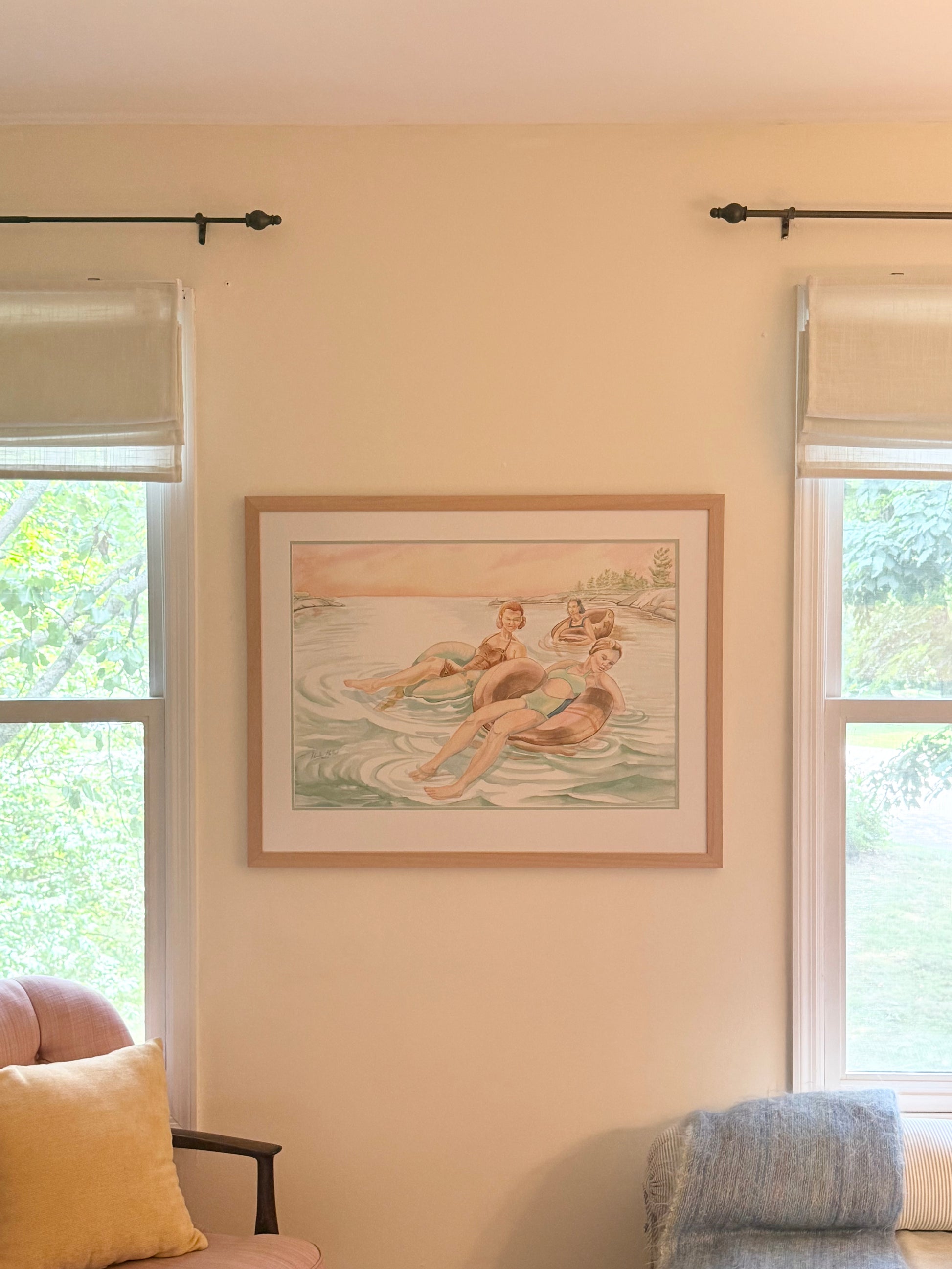 Framed original watercolor "Pink Skies" by Pamela Hallock displayed in a living room, illustrating the artwork's scale and presentation in a home setting.