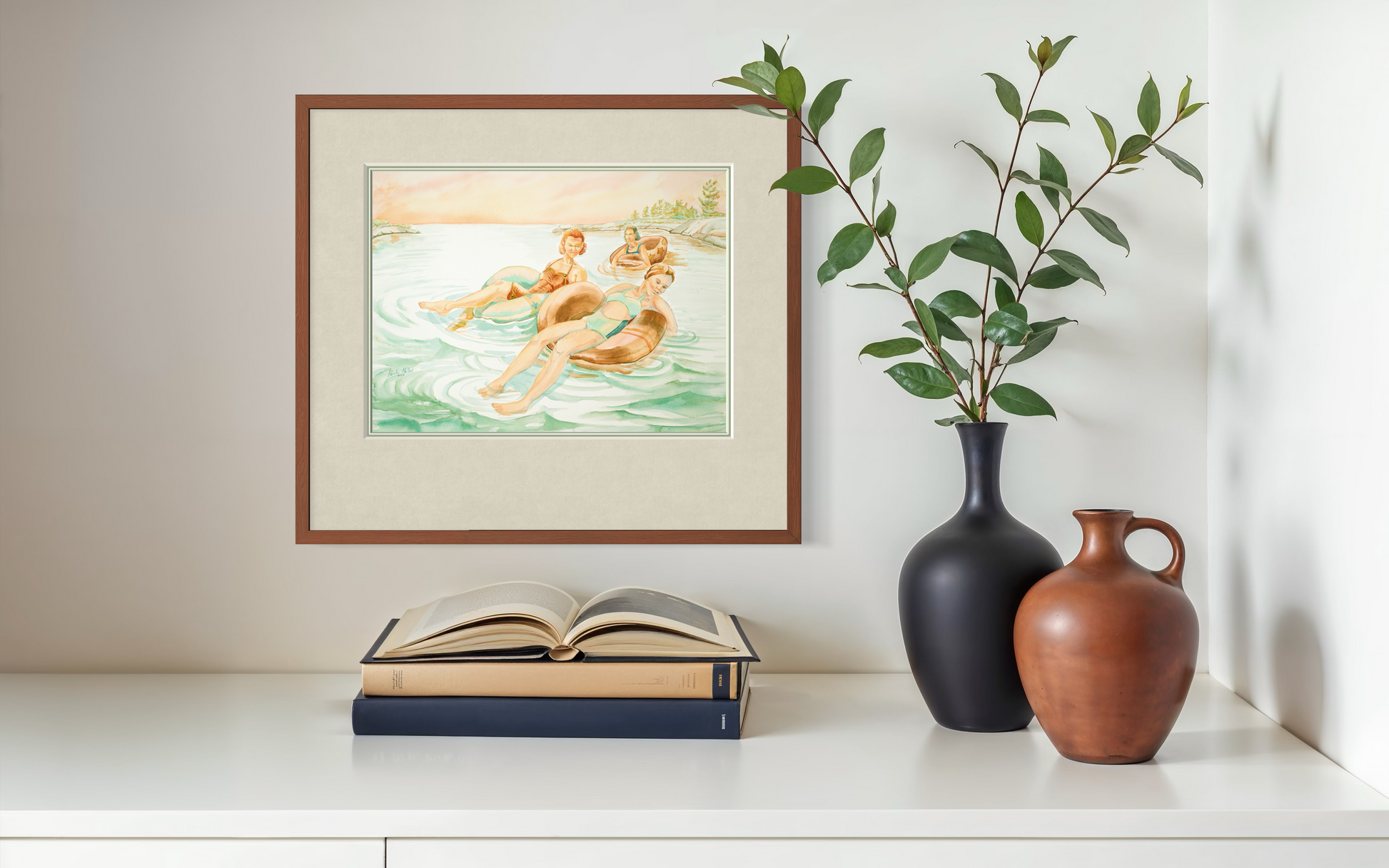 Pink Skies watercolor print styled above a shelf with simple decor accents