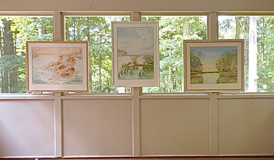 Original watercolor paintings from Pamela Hallock's Georgian Bay Collection displayed together in natural light, featuring "Pink Skies" alongside two framed Georgian Bay landscapes.
