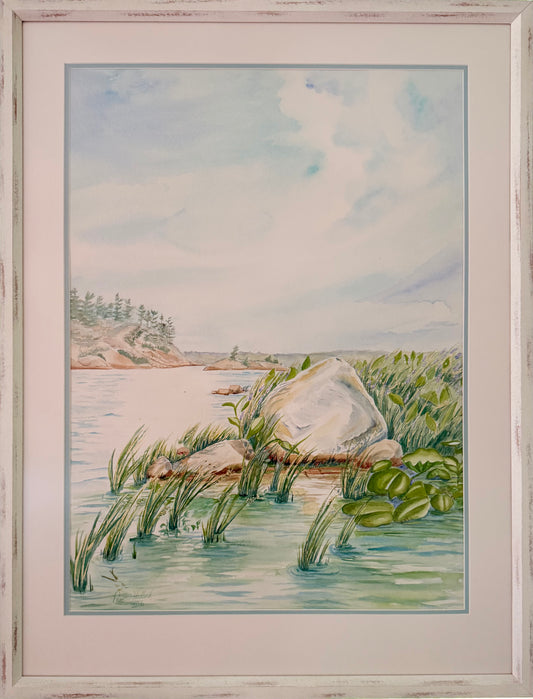 Granite and Wind original framed watercolor painting depicting a Georgian Bay shoreline with granite rock, reeds, calm water, and soft northern sky by Pamela Hallock.