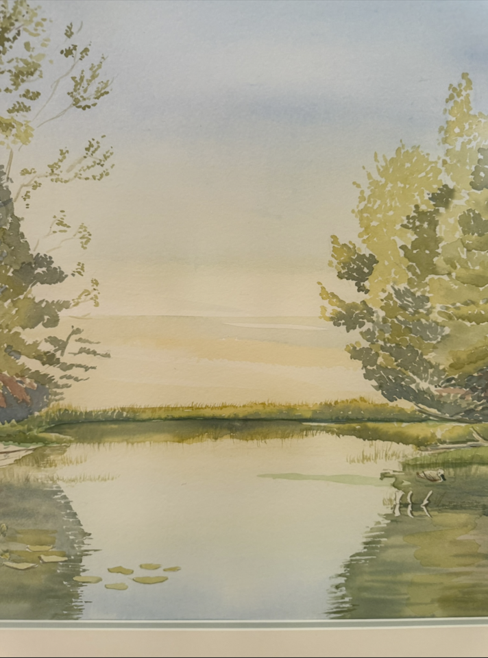 Close-up of the original watercolor "Turtle Bay," featuring calm sunrise reflections, soft morning light, shoreline pines, and peaceful waters inspired by Georgian Bay.