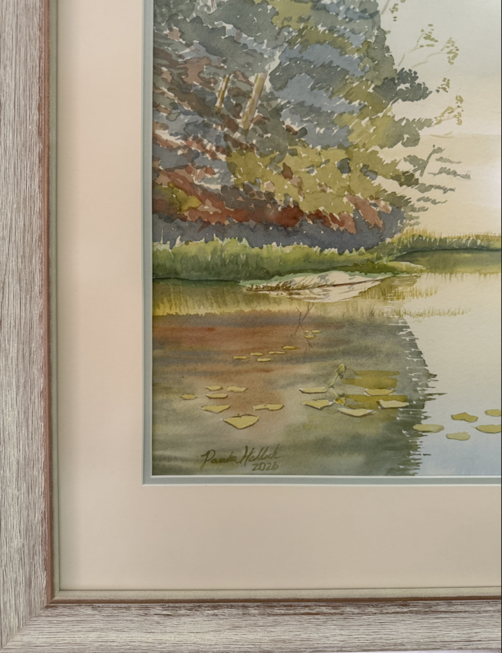 Close-up detail of the original watercolor "Turtle Bay," highlighting luminous water reflections, shoreline pines, water lilies, and the professionally framed conservation mat and wood frame.